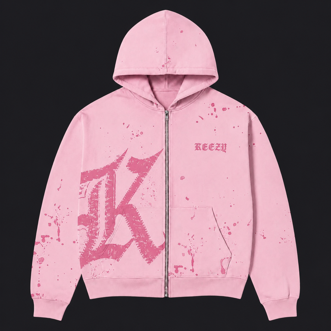 A pink zip-up hoodie with a distressed, splattered design, featuring a large stylized 'K' graphic on the front, a small 'KEEZY' logo on the chest, and a front kangaroo pocket, shown against a solid black background.