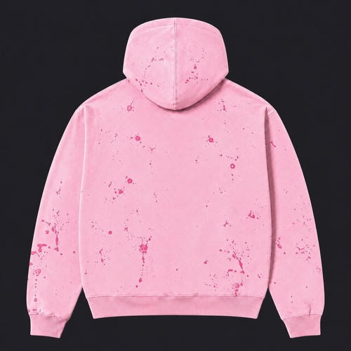 A pink hooded sweatshirt shown from the back, featuring a pink splatter or paint-splashed pattern across the fabric, set against a solid black background.