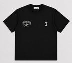 A black short-sleeve crewneck t-shirt with a white distressed graphic on the left chest featuring the word 'KEZEY' and a star, and a distressed white number '7' on the right chest. The inner neck label shows the brand 'keazy'.